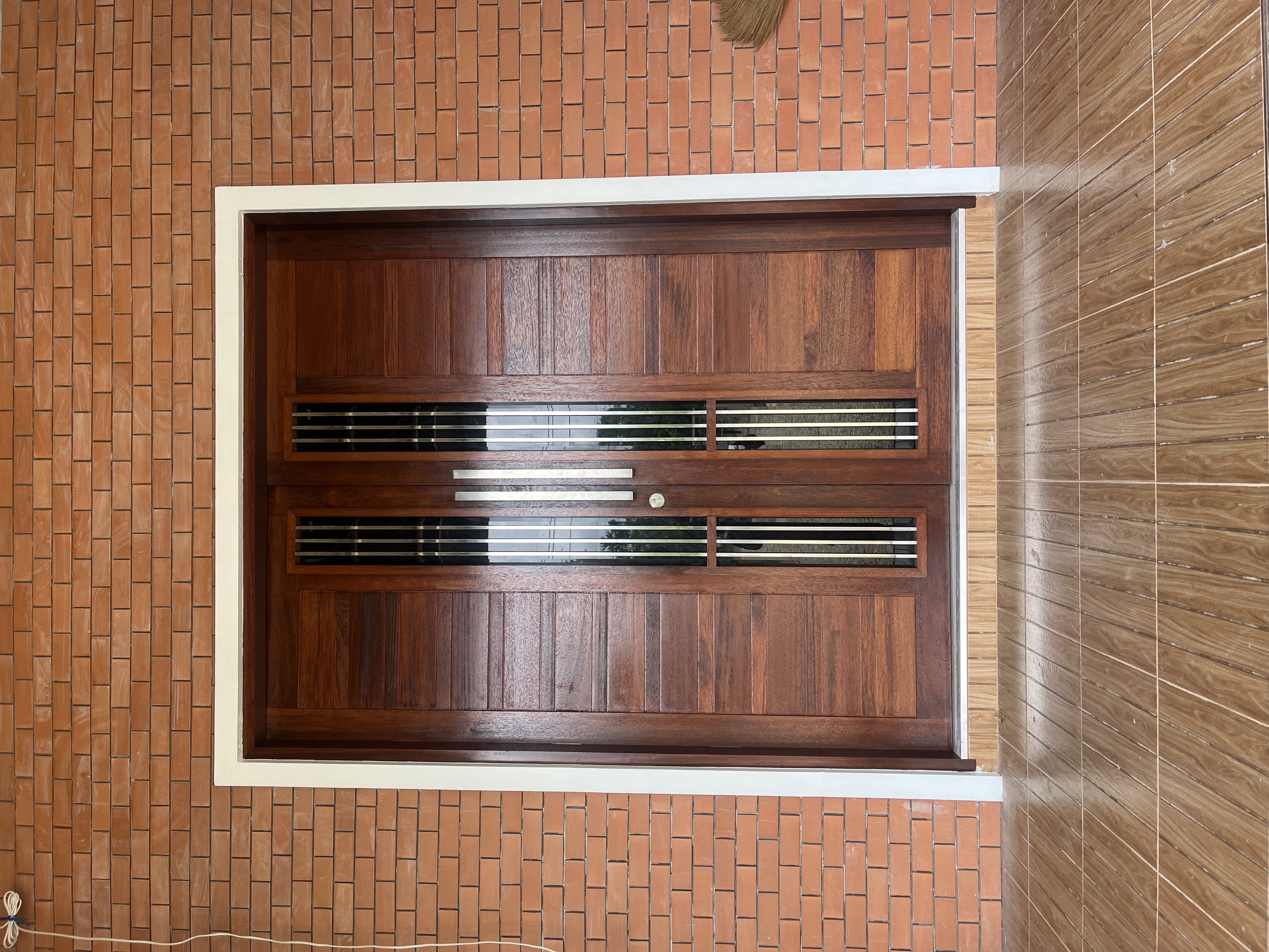 Site photograph of the Thasala house: Entrance door and wall finish